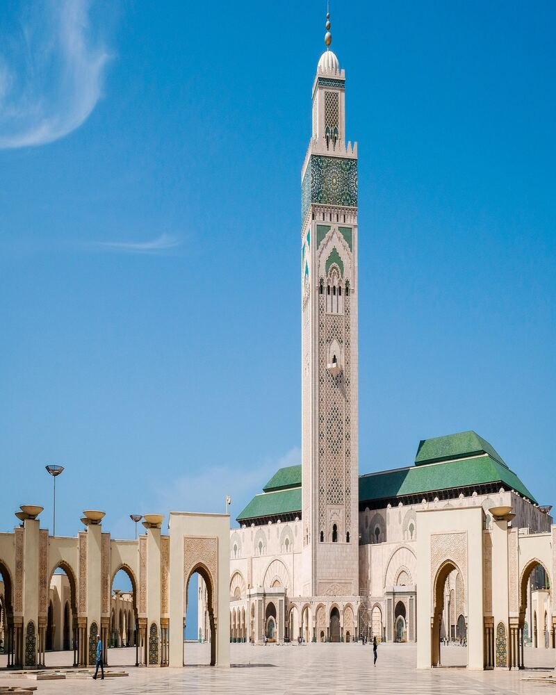 Hassan II Mosque minaret lit up against the Atlantic Ocean coast in Casablanca Morocco