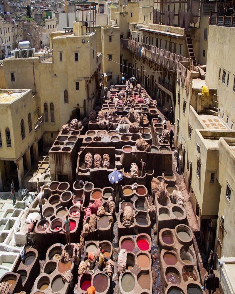 Traditional stone leather dyeing vats at the historic Chouara Tannery in Fes el-Bali medina Morocco